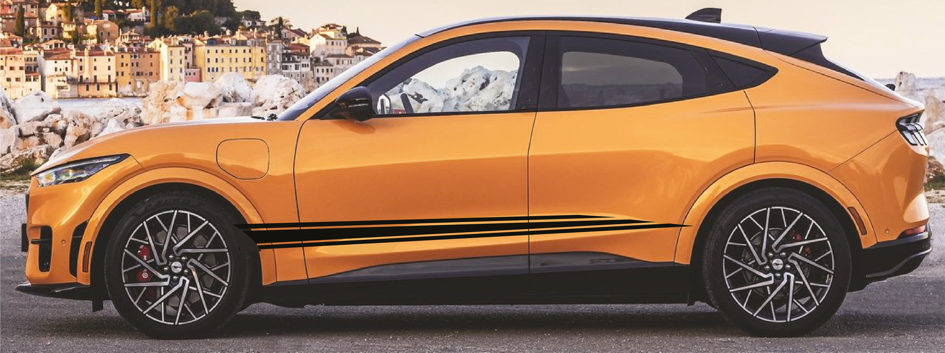 Orange SUV with black roof and side stripes on a scenic background