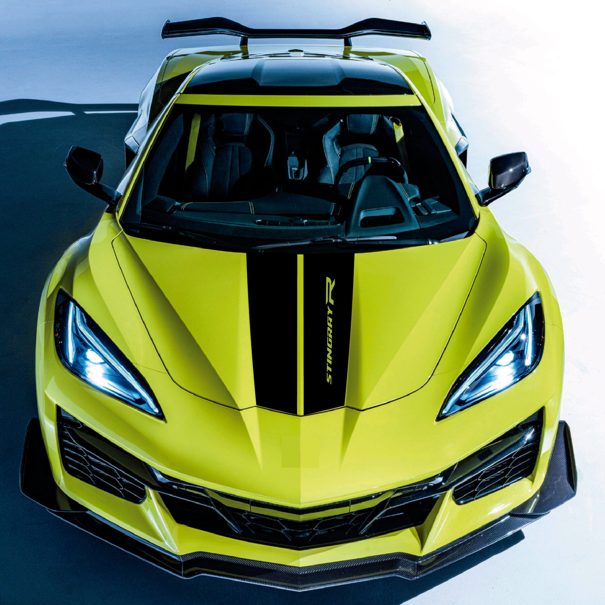 Lime green sports car with black accents on a gradient background