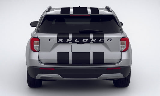 Back view of a silver Ford Explorer with black and white stripes on a white background