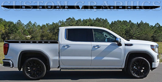 A white GMC Sierra truck with a set of premium vinyl stickers on the side, featuring the brand's logo and design.