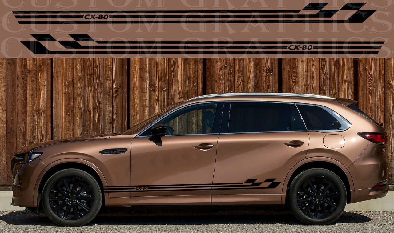 Bronze SUV with black wheels and decals against a wooden background