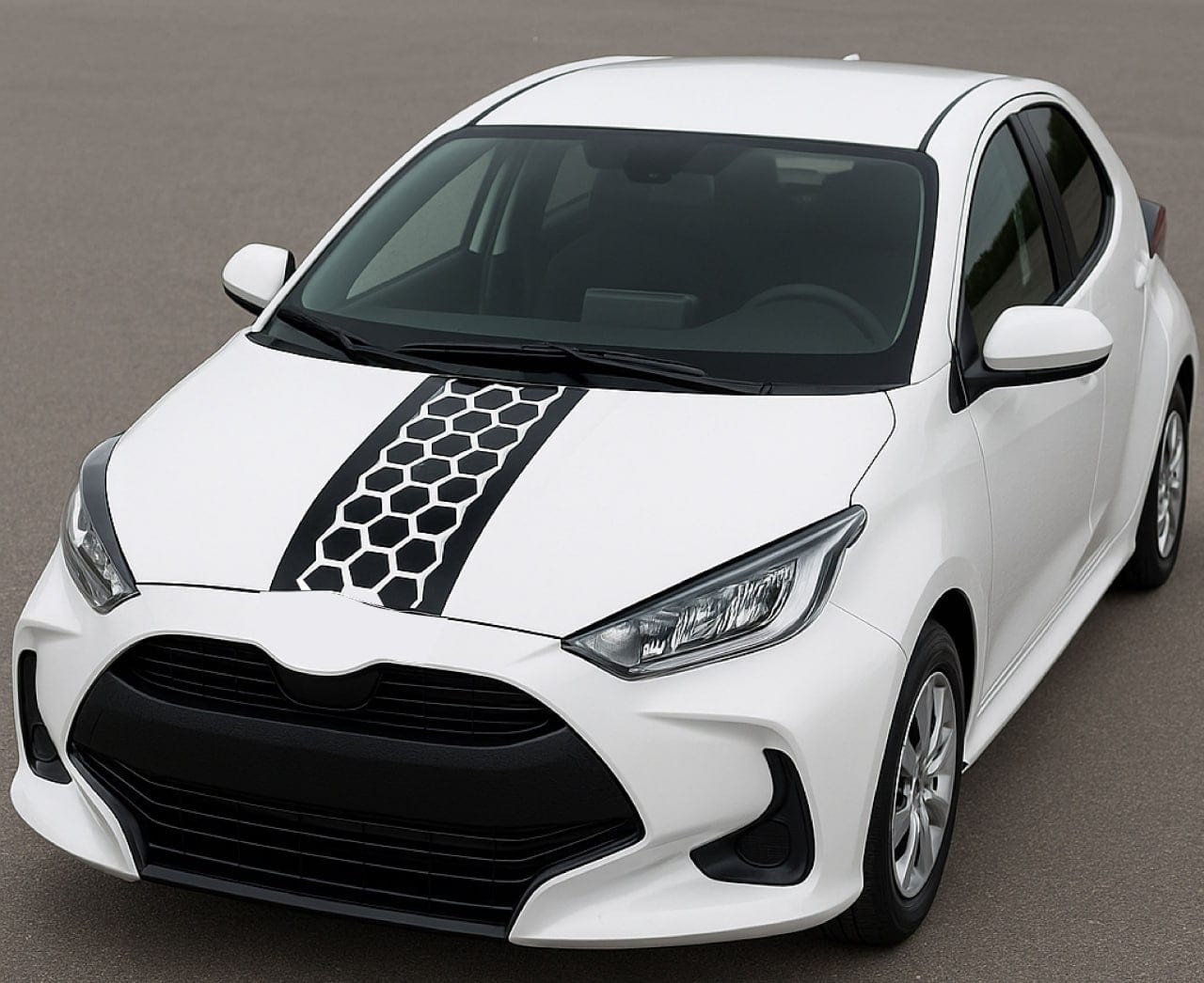 White car with black honeycomb design on the hood against a gray background