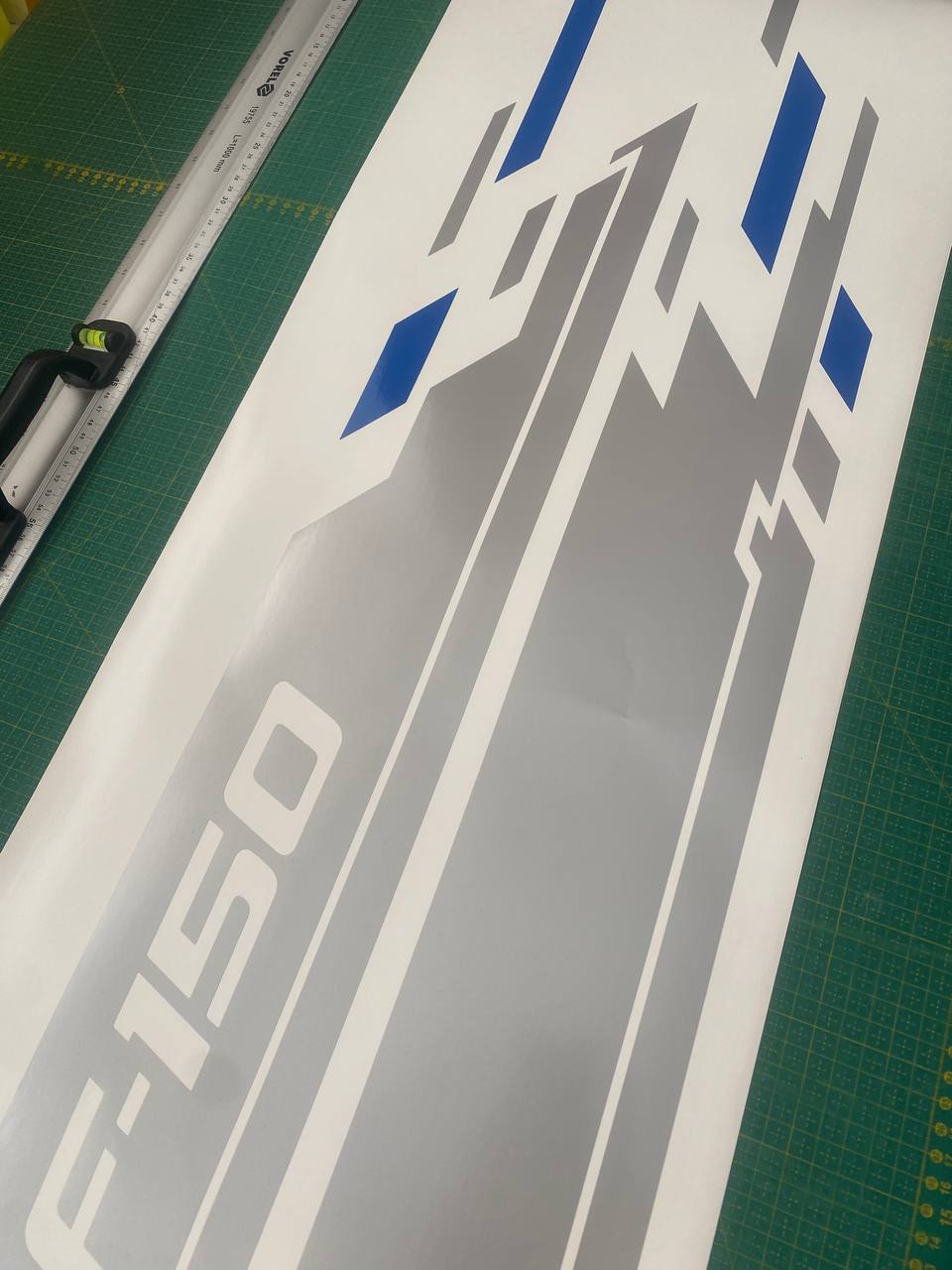Ford F-150 decal on a cutting mat with a ruler for scale.