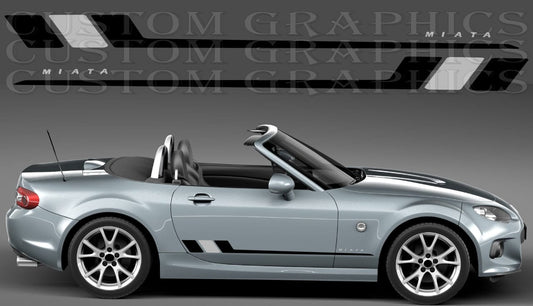 A silver convertible sports car shown in side profile on a gray studio background, with black and white graphic decals displayed above. The decals include the word 'MIATA' and angular stripe designs, suggesting a car wrap or decal product.